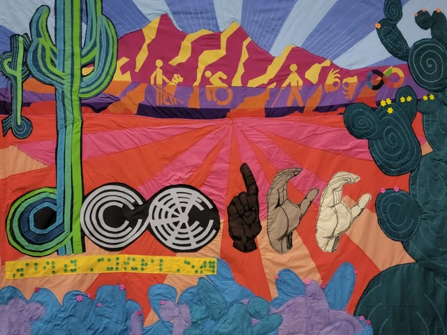 A quilt with the words DCC and a desert scene.