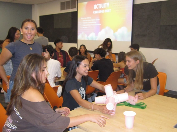 Latine Student Association a group of students smiling sitting down at a table