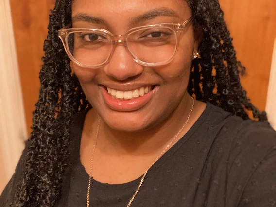 Girl with glasses smiling with white teeth 
