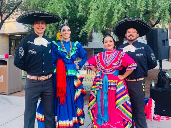 A group of students wearing traditional folklorico outfits