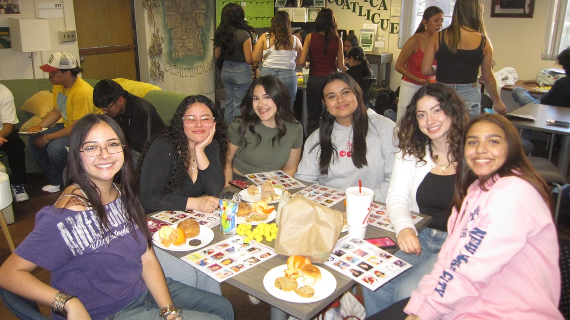 Latine Student Association a group of students sitting down sharing a meal