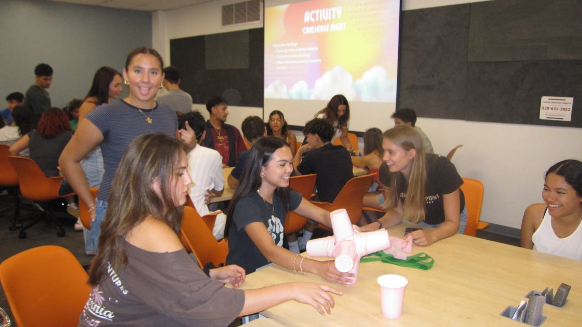 Latine Student Association a group of students smiling sitting down at a table