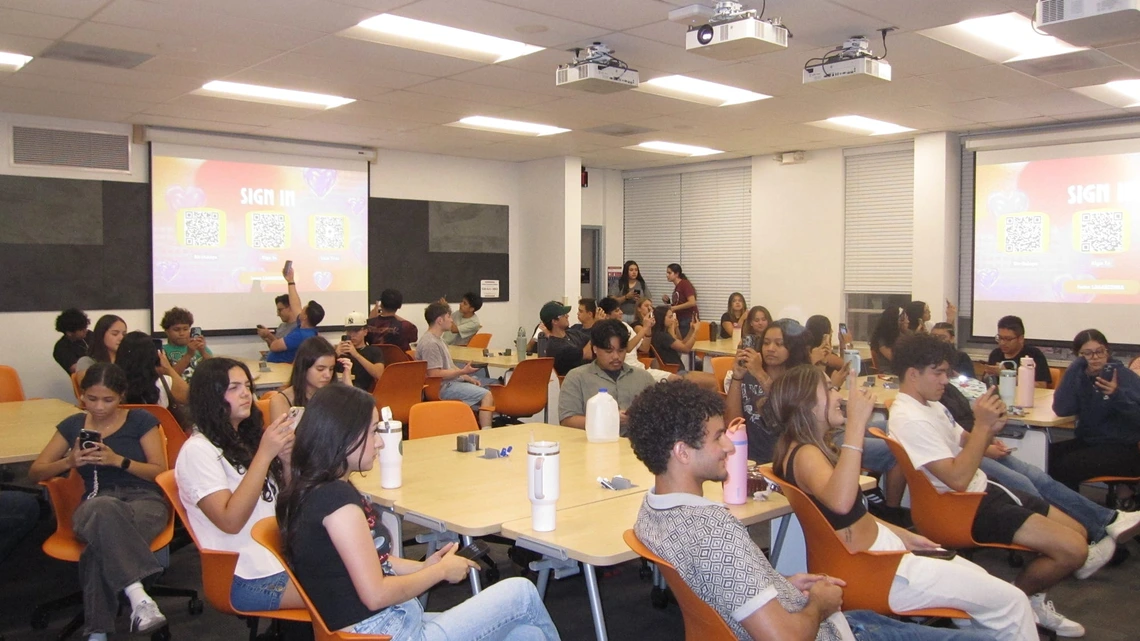 Latine Student Association a group of students sitting down in a classroom