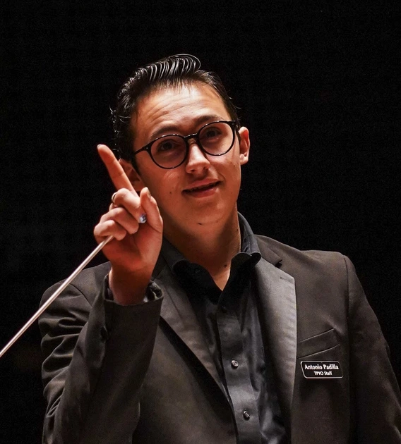 Student standing, wearing a blazer 