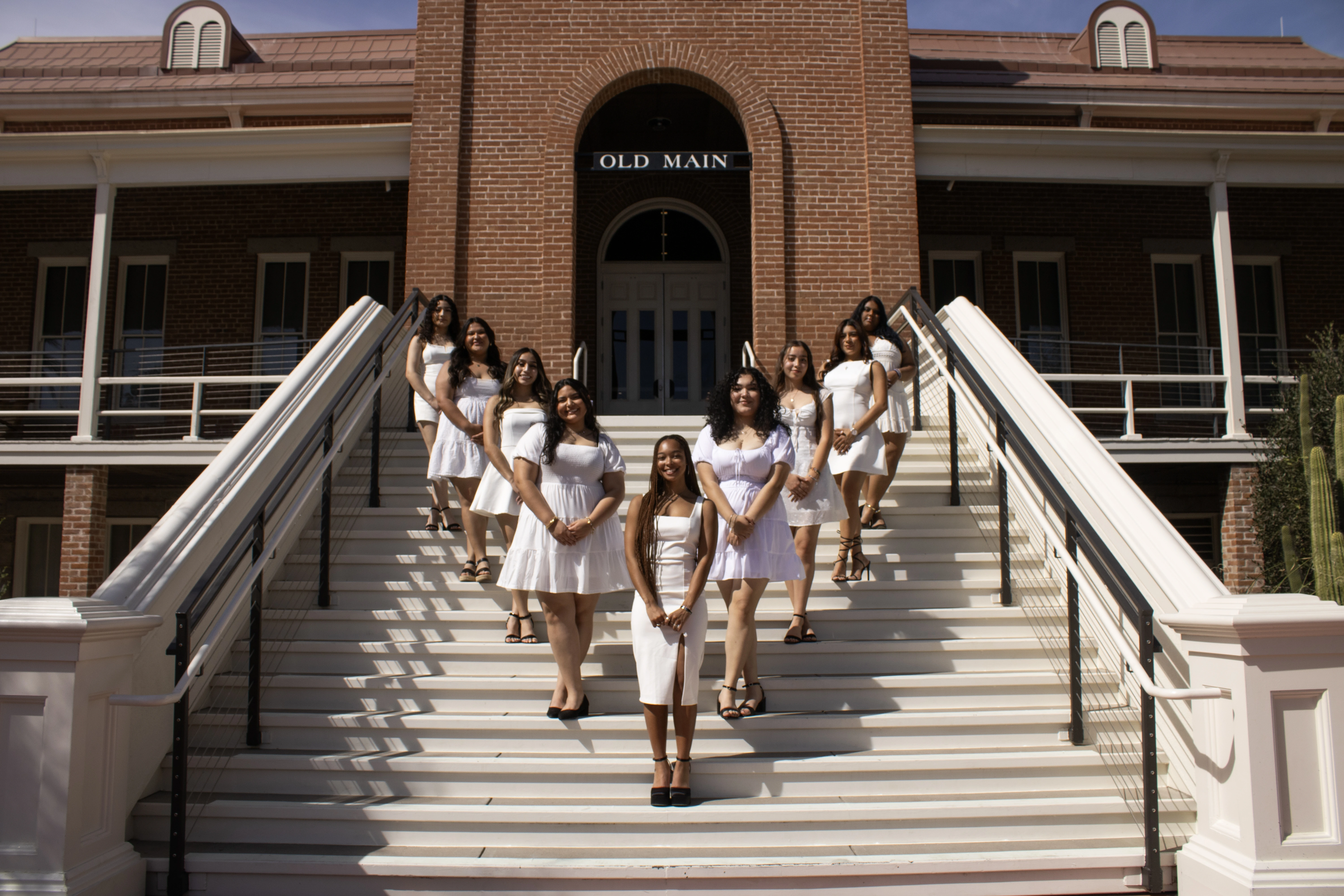 members of Sigma Lambda Gamma standing in front of Old Main