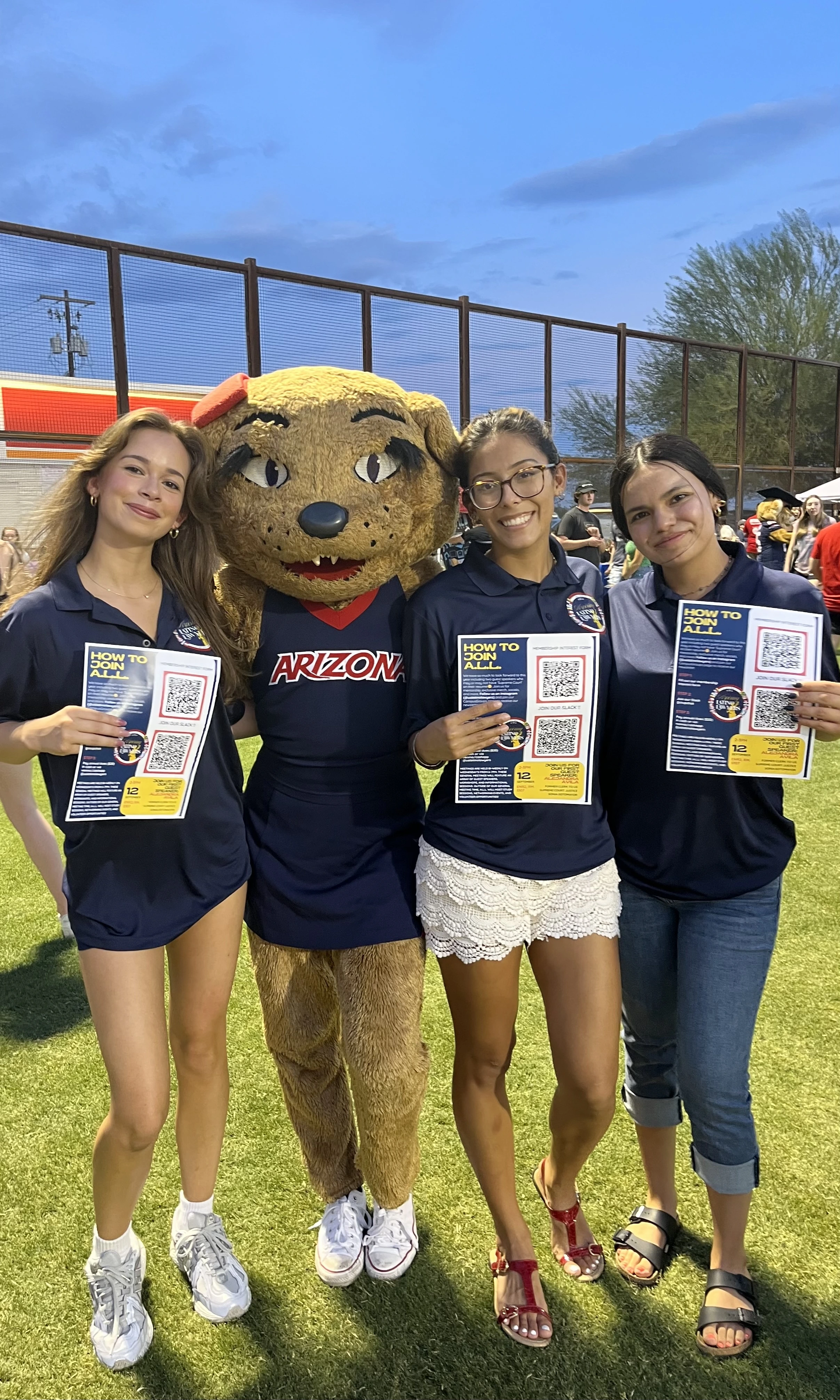 3 students standing with Wilma the UA mascot