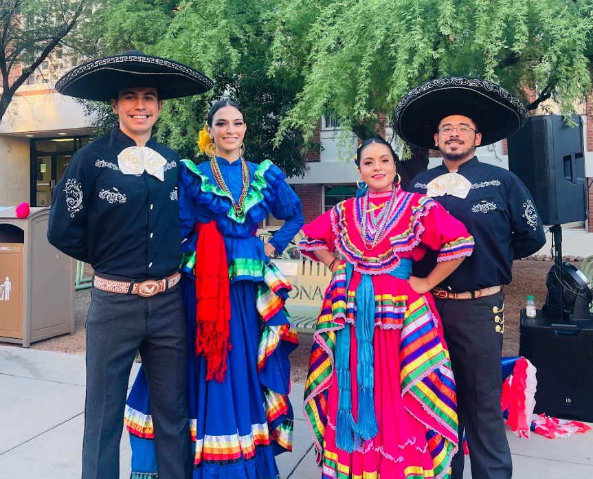 A group of students wearing traditional folklorico outfits